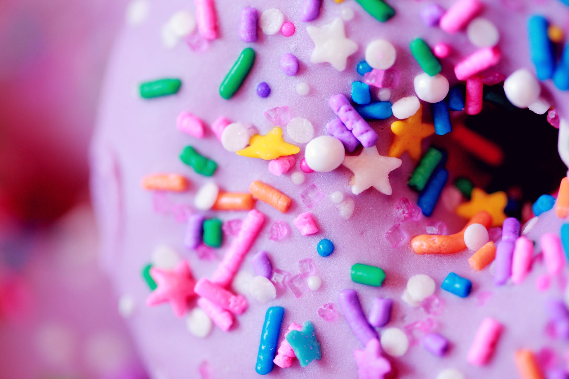 pink doughnut with colorful sprinkles