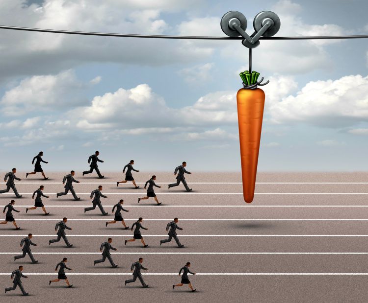 People chasing carrot on stick