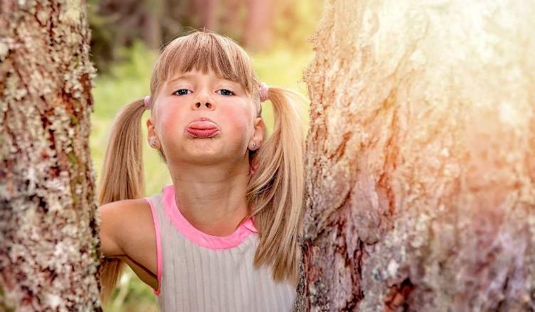 child rude sticking tongue out